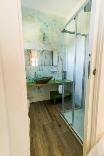 a bathroom with a sink and a glass shower at Villa Le Chianche in Vico del Gargano