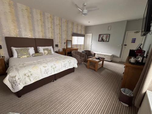 a bedroom with a bed and a living room at The Clifton in Shanklin