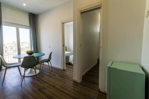a room with a table and chairs and a bedroom at Villa Le Chianche in Vico del Gargano