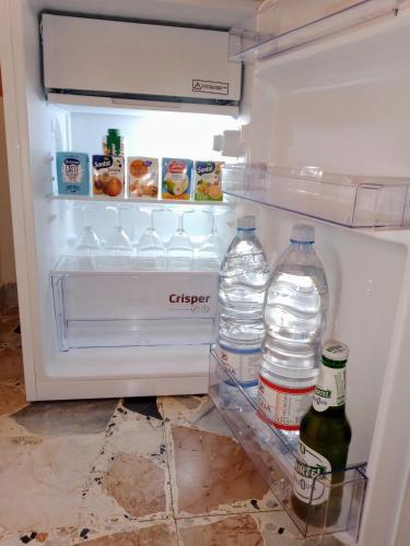 an open refrigerator with two bottles of water in it at Quedar-se a l'Alguer in Alghero