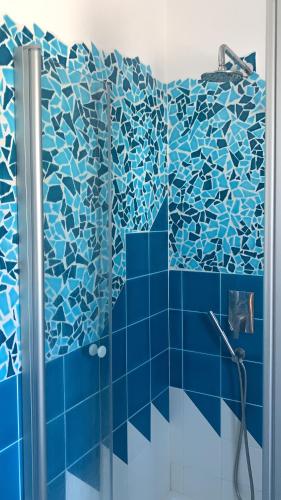 a bathroom with a shower with blue tiles at Vista mare montagna da Marcello in Cala Gonone