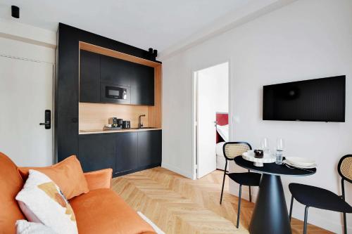 un salon avec un canapé et une table dans l'établissement Cozy Entire Apartment Near the Eiffel Tower, à Paris