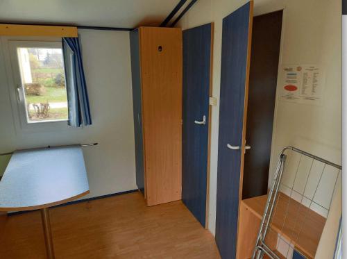 an empty room with a door and a window at Camping 3 étoiles - efaicg in Auxonne