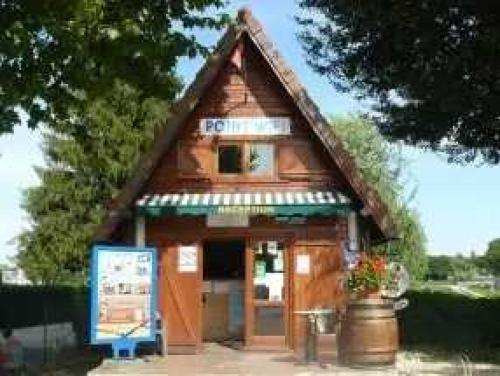 a small wooden building with a sign in front of it at Camping 3 étoiles - efaicg in Auxonne
