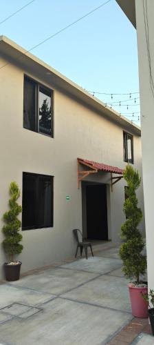 a building with a black bench in front of it at Casa Natla in San Lorenzo Tlalmimilolpan