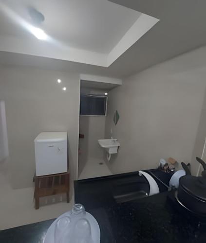 une salle de bain avec un lavabo et des toilettes dans une chambre dans l'établissement lindo apartamento recreio dos bandeirantes, à Rio de Janeiro