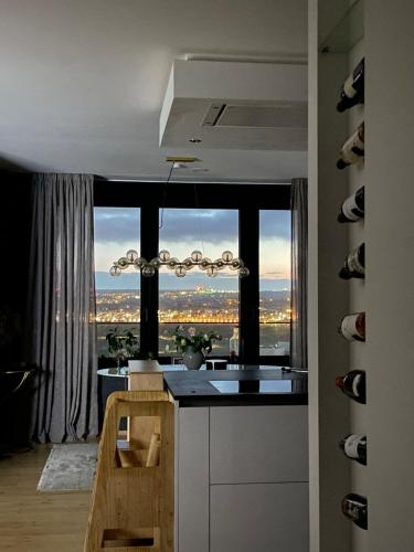 a kitchen with a view of a city from a window at Elegant Escape Pool & Sauna in Luxembourg