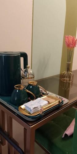 a table with two tea pots on top of it at Kasara Serenity Condotel in Manila