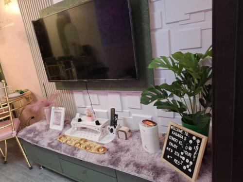a counter top with a sewing machine and a chalkboard at Kasara Serenity Condotel in Manila