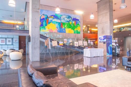 a lobby with a large painting on the wall at VIP Executive Arts Hotel in Lisbon