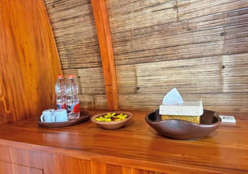 two bowls of food sitting on top of a wooden counter at Lagoona Beach Bungalows - Eco Bungalows Batukaras in Batukaras