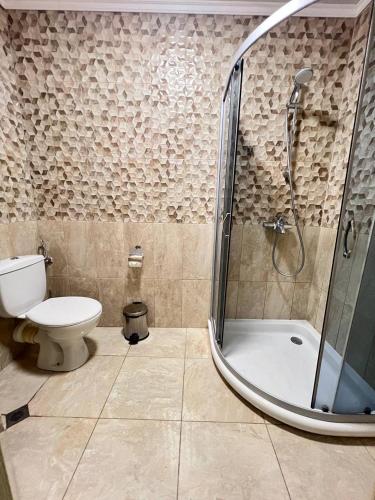a bathroom with a shower and a toilet at Family Hotel Gallery - Sunny Beach in Sunny Beach
