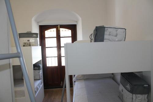 a room with a staircase and a door and a room with boxes at Pórtico del Azahín in Cazalla de la Sierra