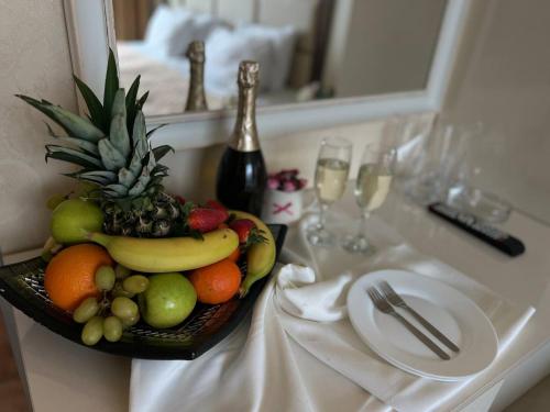 a bowl of fruit on a table in a hotel room at Family Hotel Gallery - Sunny Beach in Sunny Beach