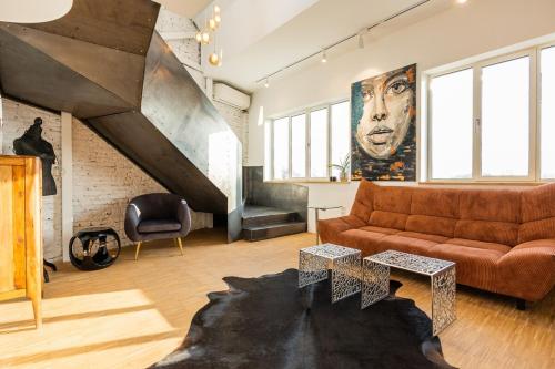 a living room with a couch and a staircase at Apartment Musala N 05 in Varna City