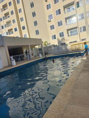 a swimming pool in front of a building at Condomínio Reserva da Colina in Salvador