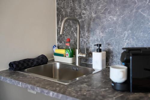a kitchen counter with a stainless steel sink at Cozy & Fully Equipped Studio in Eindhoven 2 in Eindhoven