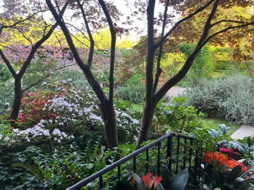 a garden with colorful flowers and trees at Boutique Apartment Casa Angela in Udine