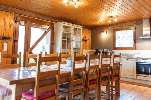 a kitchen and dining room with a table and chairs at La Grange des Mios in La Bresse