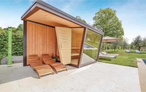 a small pavilion with chairs and an umbrella at Villa Montello Pool, Jacuzzi, Ac, Wifi, Treviso in Volpago del Montello