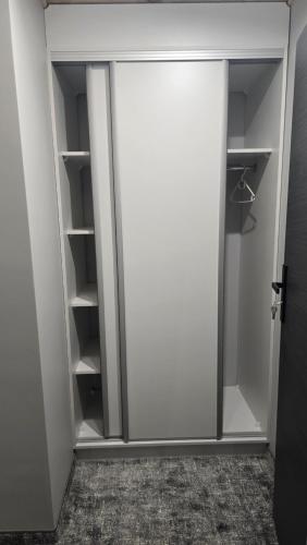 a sliding glass door in a walk in closet at Pensjonat Lubianka in Starachowice