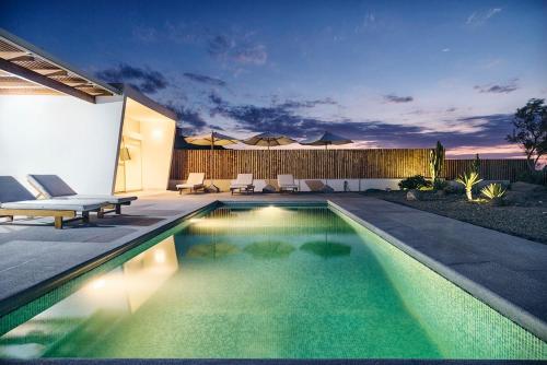 a swimming pool in the backyard of a house at Casa Wayta in Los Órganos