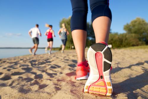 a person standing on the beach with their shoes on at SCHLOSS Fleesensee in Göhren-Lebbin