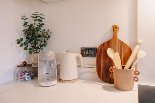 a kitchen counter with various kitchen utensils on it at Elegant Hideaway City Centre,1 Bed Flat, 3rd Floor in Bath