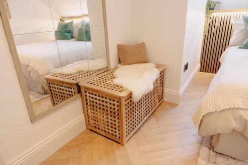 a room with a mirror and a chair and a bed at Elegant Hideaway City Centre,1 Bed Flat, 3rd Floor in Bath
