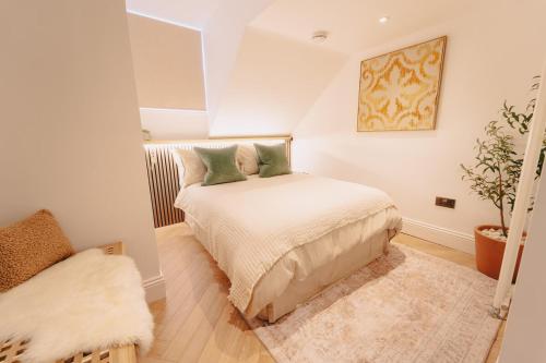 a small bedroom with a bed and a chair at Elegant Hideaway City Centre,1 Bed Flat, 3rd Floor in Bath
