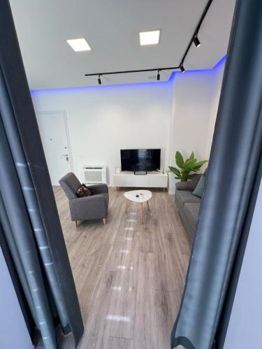 a living room with a couch and a table at Sunflower Apartment in Tirana