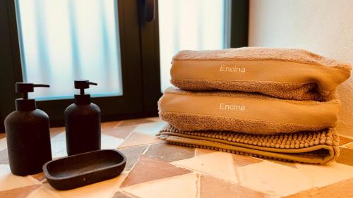a pile of towels and two bottles of soap on a counter at Mondejar 14 Coliving Centro in Estepona