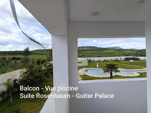 a view from the balcony of a villa with a swimming pool at GUITAR PALACE - Chambres d'hôtes in Bni Quolla