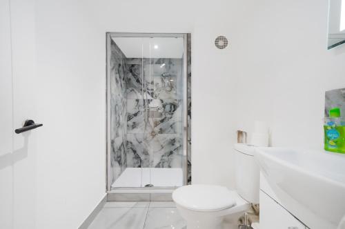 a white bathroom with a shower and a toilet at 30 percent off! Elegant Yorkshire Abode - Great Location - Sleeps 19 in Castleford