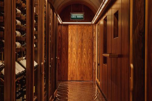 a corridor of a room with a wine cellar at The Connaught, Maybourne in London
