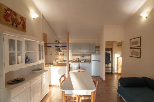 a kitchen and living room with a table and a couch at Agriturismo Fontenuova in Saturnia