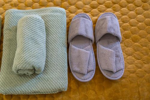 two socks and a pair of shoes on a bed at Stylish 2 Bedroom Apartment in Belfast in Belfast