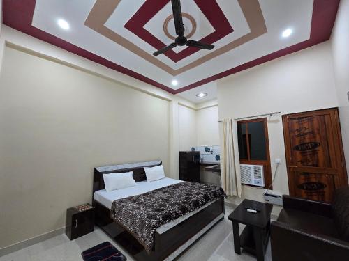 a bedroom with a bed and a coffered ceiling at Hotel Siddhi Palace, Ayodhya Near Ram Mandir in Ayodhya