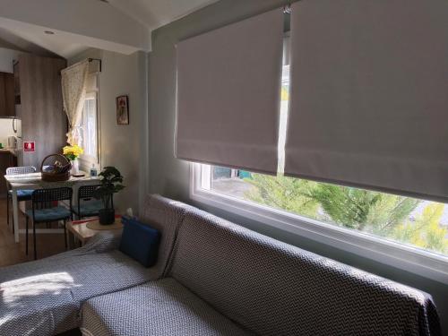 a living room with a couch and a window at Io's Guest House in Ofrínion