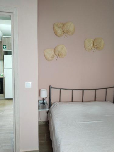a bedroom with a bed and two hats on the wall at Io's Guest House in Ofrínion