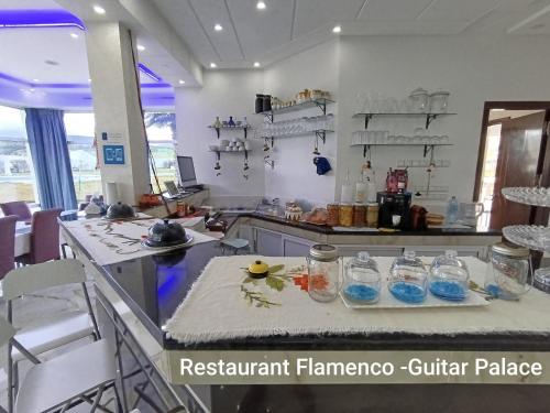 a kitchen with a counter with glasses on it at GUITAR PALACE - Chambres d'hôtes in Bni Quolla
