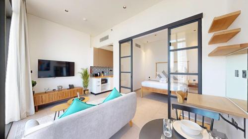 a large living room with a couch and a bed at The Community Jumeirah Village in Dubai