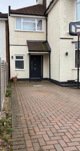 a brick driveway in front of a house at Luxury modern apartment with free private parking in Saint Albans