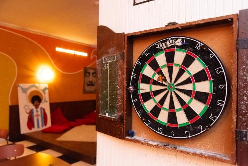 a dart board on a wall in a room at Sunflower Beach Backpacker Hostel & Bar in Rimini