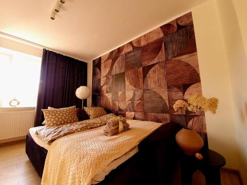 a bedroom with a bed with a teddy bear on it at Apartament Słoneczny in Wałbrzych