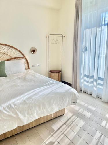 a bedroom with a bed and a large window at Bird Walking in Yuli