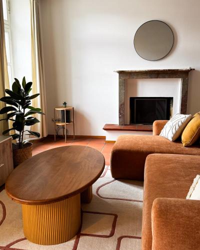 a living room with a couch and a table at Piazza Grande Duplex in Locarno