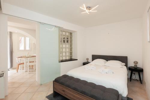 une chambre avec un lit et une salle à manger dans l'établissement Immogroom - charmant logement à 2 pas du port, à Cannes