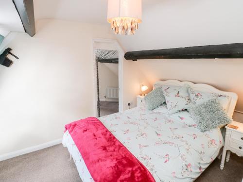 a bedroom with a bed and a mirror at Caedmon's Rest in Whitby