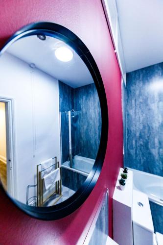 a mirror in a bathroom with a sink and a tub at 2 Bedroom Home-Free Parking-Perfect for Contractors in Pallion